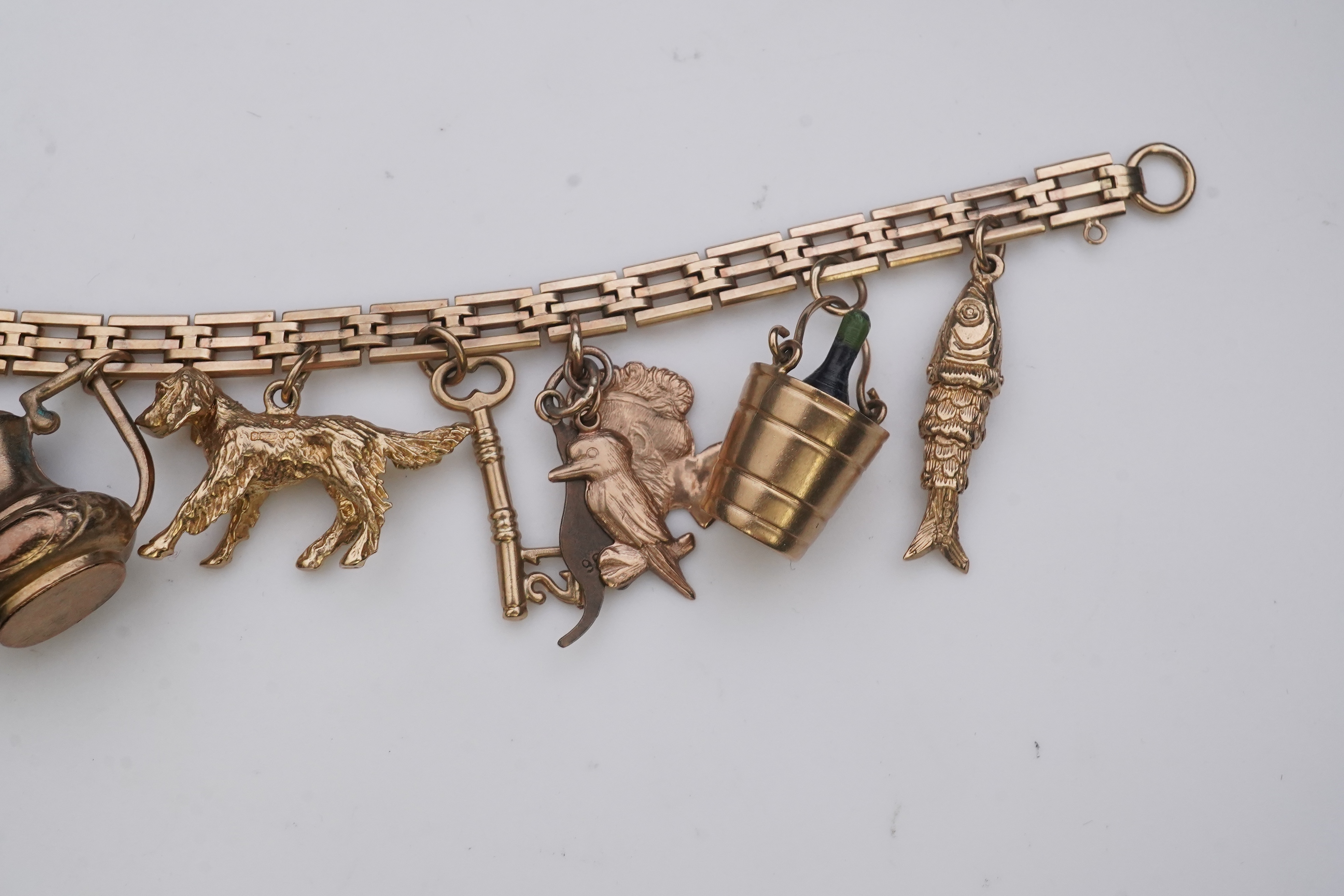 A charm bracelet, mid 20th century